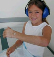 Little girl showing her arm after cast was removed